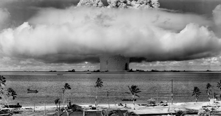 grayscale-photo-of-explosion-on-the-beach-73909-1